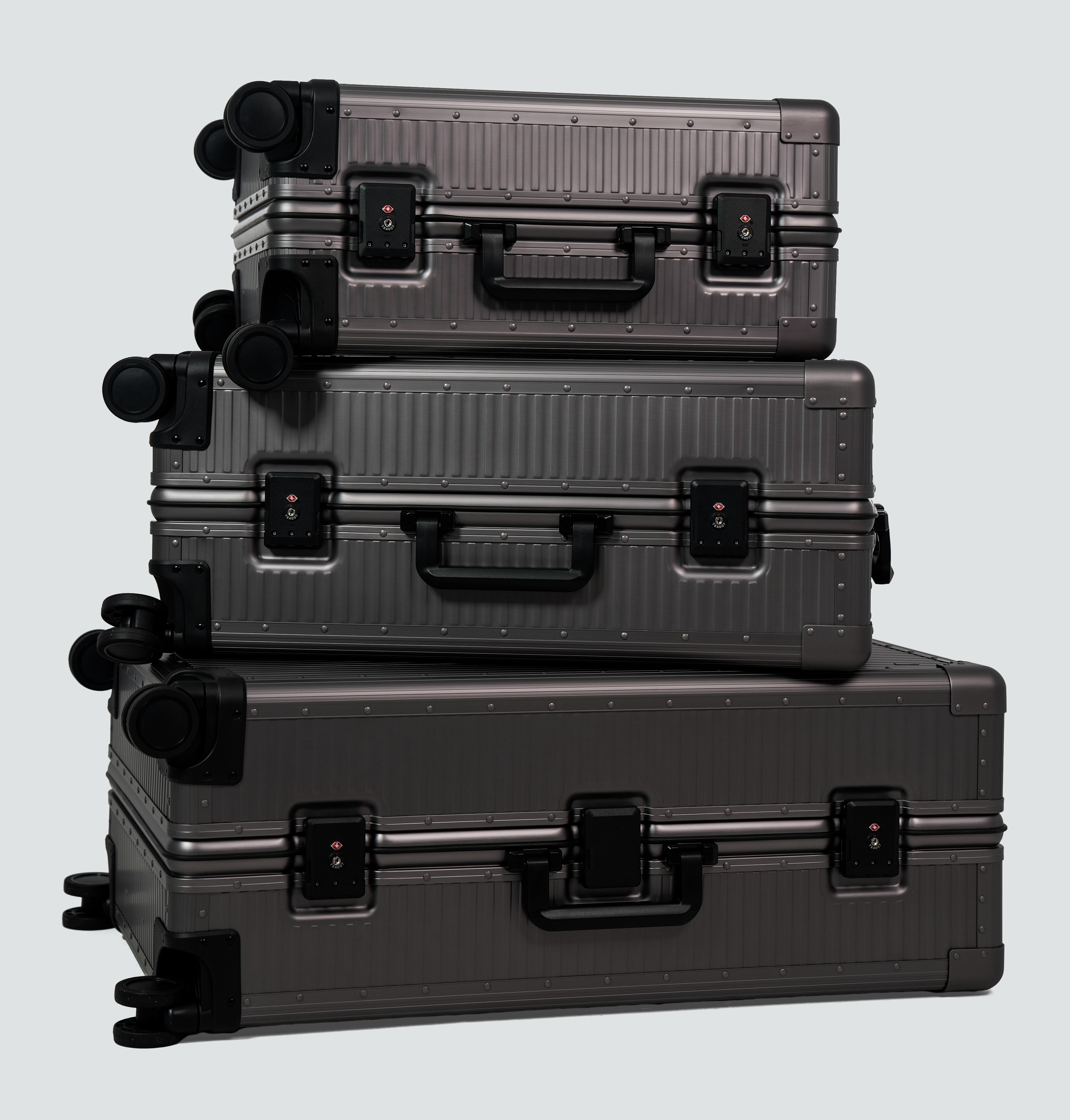 A stack of three high-end Loure travel suitcases demonstrating durability and premium materials